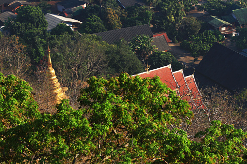 Heritage Golden Buddha statue and pagoda located in the forest and on the mountain in northern of Thailand Bird eye view