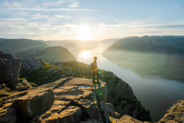 istock Woman standing on Preikestolen and looking at view 1487492064