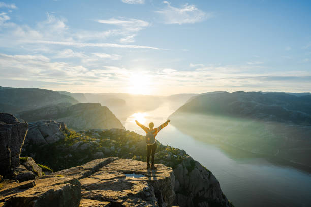 istock Woman standing on Preikestolen and looking at view 1487492065
