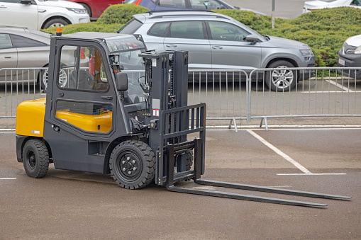 Long Forks at Forklift Truck With Closed Cabin Outside