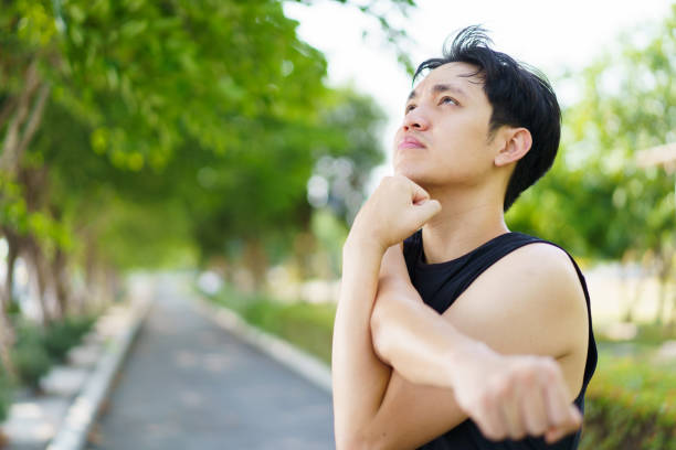istock Asian sportsman stretching himself before exercise. 1487493452