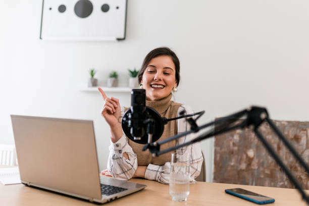 istock Young smiling women recording podcast and doing live streaming using microphone and headphones in recording studio 1487493824
