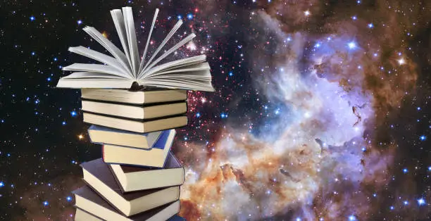 Image of a stack of books and an open book on top of the stack against the backdrop of a cosmic starscape