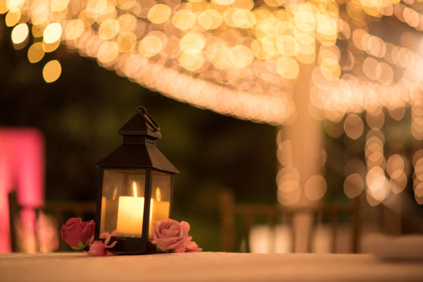 istock Beautiful candle lantern table decoration with bokeh lights in background 1487494200