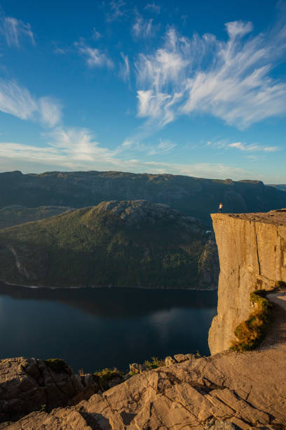 Man standing on Preikestolen and looking at view Man  standing on Preikestolen and looking at scenic view of Lysefjorden lysefjorden stock pictures, royalty-free photos & images