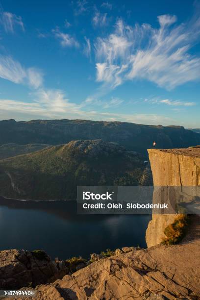 Man Standing On Preikestolen And Looking At View Stock Photo - Download Image Now - Lysefjorden, Norway, Preikestolen - Norway