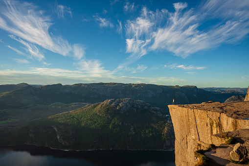 Man  standing on Preikestolen and looking at scenic view of Lysefjorden