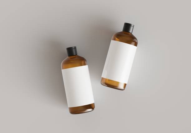 istock Two brown plastic cosmetic containers with labels, shampoo bottles laying on gray background front view 3D render mockup 1487494506