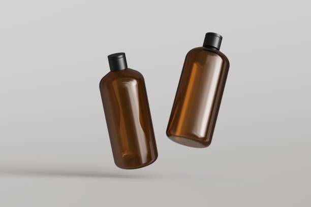 istock Two brown plastic cosmetic containers, shampoo bottles floating on gray background front view 3D render mockup 1487494527