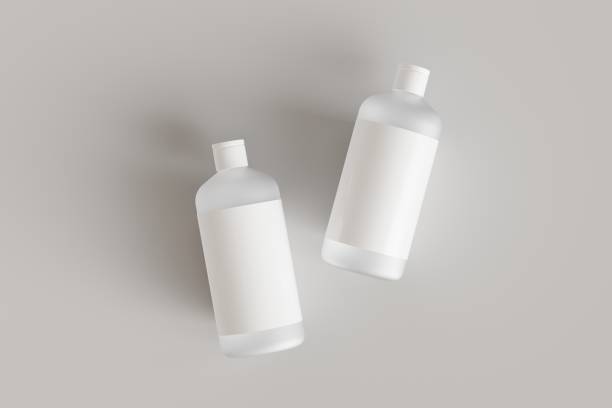 Two plastic cosmetic containers with labels, shampoo bottles laying on gray background front view 3D render mockup stock photo