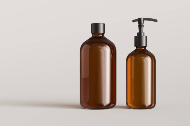 istock Two brown plastic cosmetic containers, shampoo bottle and soap pump on gray background front view 3D render mockup 1487494594