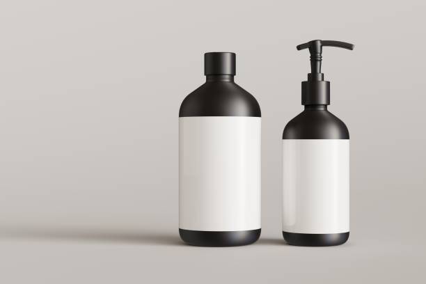 istock Two black cosmetic containers with labels, shampoo bottle and soap pump on gray background front view 3D render mockup 1487494614