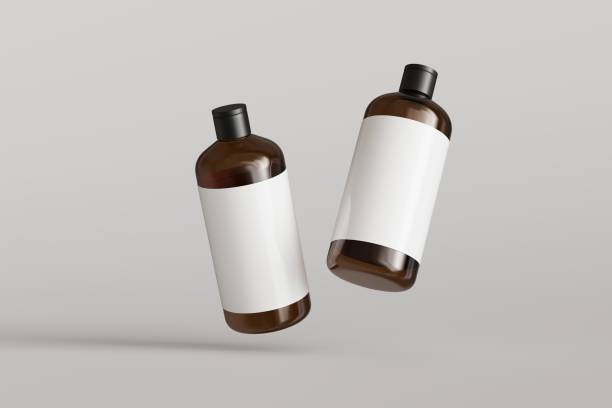 グレイの背景にラベル付きの2つの茶色のプラスチック化粧品容器、シャンプーボトルが浮かぶ正面図3Dレンダリングモックアップ
