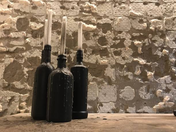 istock The bottle is black and has a white candle on top. 1487496910