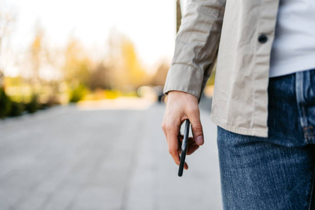 istock Young Man Holding His Phone Outdoors 1487500612