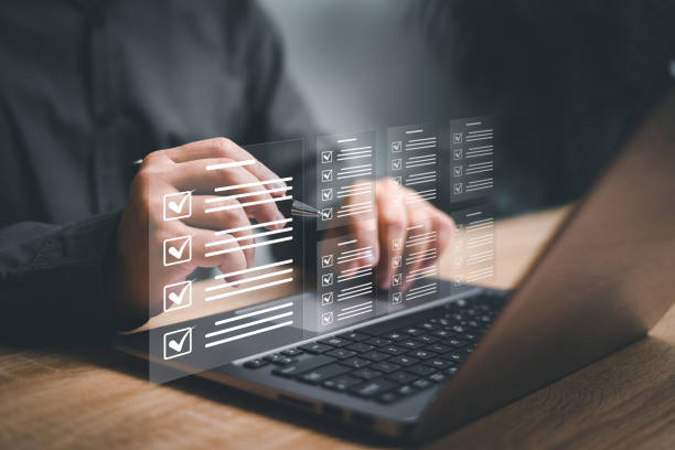 istock Electronic smart checklist and document management on virtual screens, Businessman use laptop and check electronic documents on digital documents, paperless offices concept and technology 1487502380