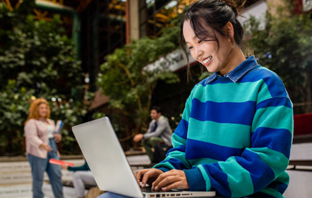 istock Portrait of female student siting in campus using laptop. 1487502980