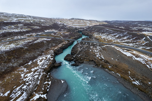 Aerial view on a road crossing the glacial river in South Iceland. Katla volcano (Myrdalsjokull glacier) in the background.