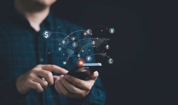 istock Businessman using telephone with world map and currency sign include dollar euro pound sterling yen yuan won for technology currency exchange and money transfer , Financial and investment concept. 1487503486