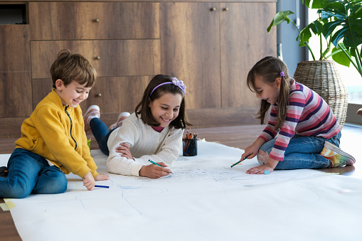 Children Painting Pictures Together At Home