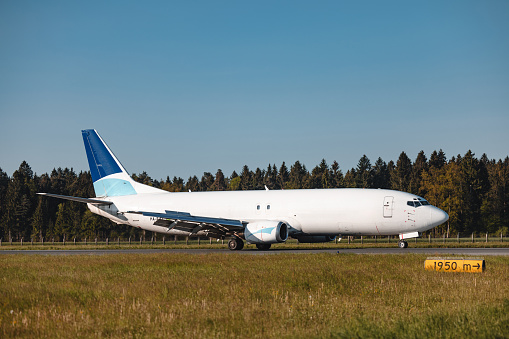 Photo of an airplane before taking off, pictured on the ground at the airport runway.