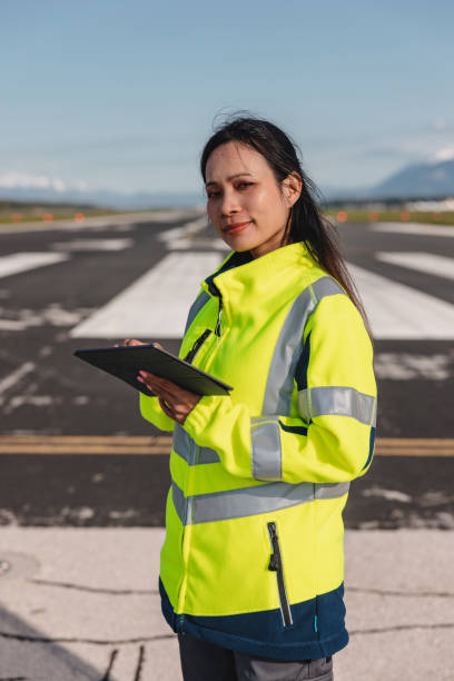 istock Happy Female Airport Worker Holding A Digital Tablet 1487505748