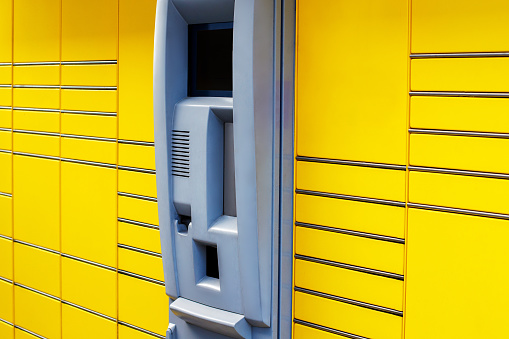 Close-up of Autonomous Yellow Parcel Locker for Delivery, Pick-up, and Payment