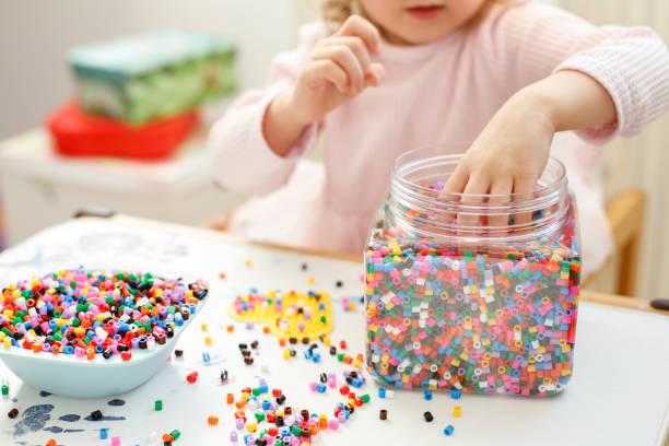istock close-up girl playing Hama Beads 1487506528