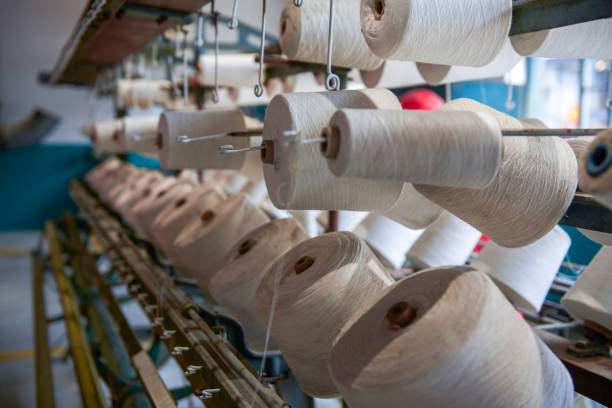 istock A row of bobbins on a cotton spinning machine 1487507722
