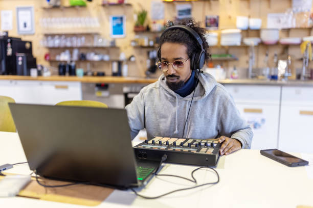 istock African musician making music with a midi controller and laptop at studio 1487508038