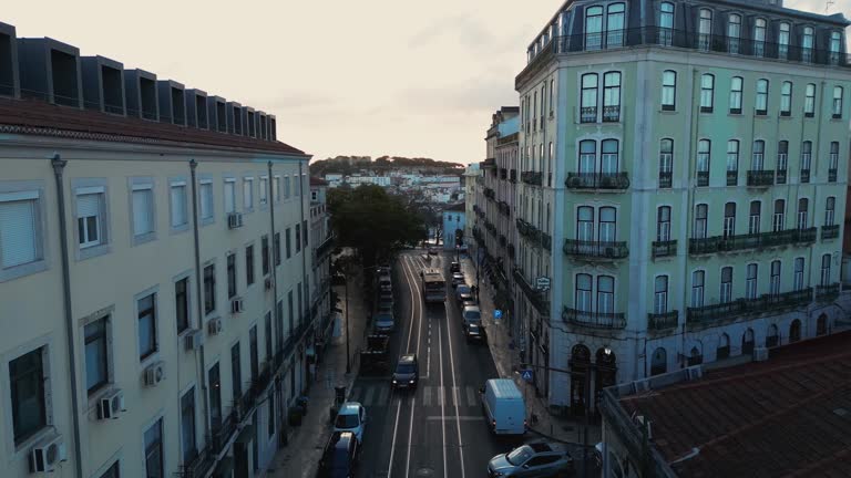 Aerial images at dawn of the city neighbourhood of Lisbon in the middle of buildings and streets