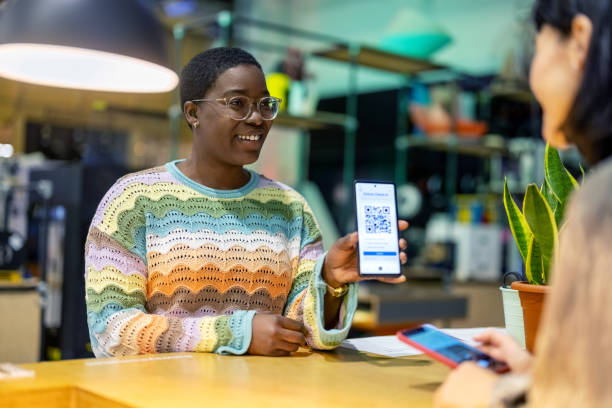 istock African woman showing QR code on her phone to the receptionist at makers space 1487508157