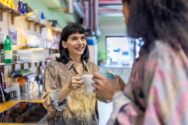 istock Two women having a casual talk during the coffee break at work 1487508164