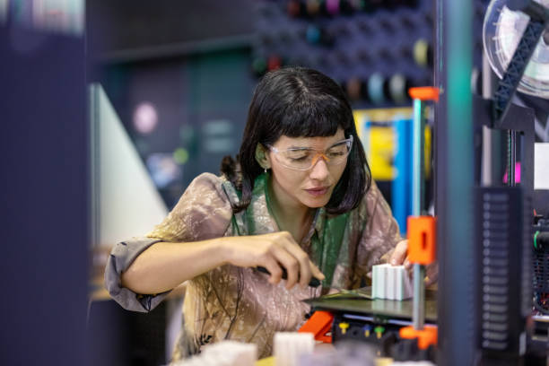 istock Young woman 3D-printing some parts at makers space 1487508205
