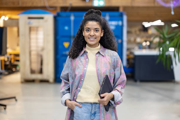istock Beautiful young african woman standing at creative makers space 1487508237