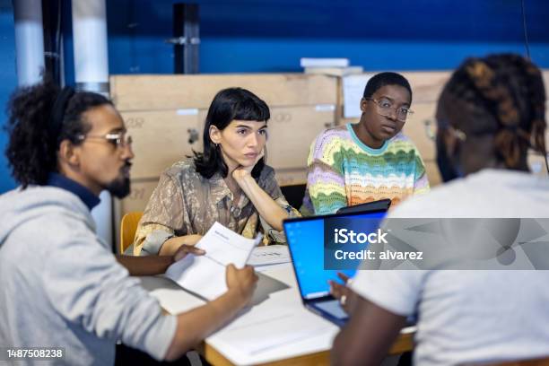 Professionals Collaborating On A New Project At Creative Workplace Stock Photo - Download Image Now