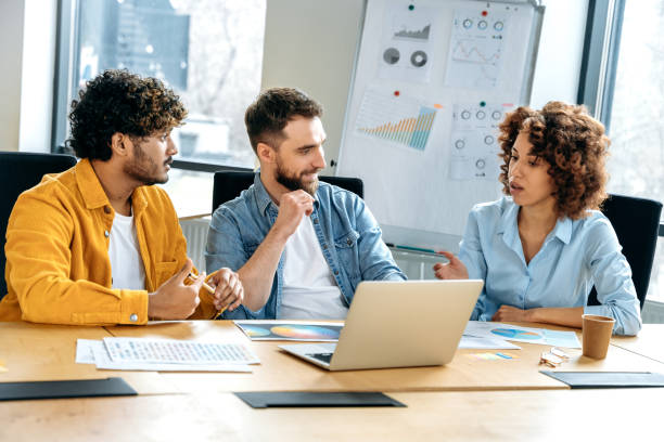 istock Design team. A group of successful multiracial colleagues, creative designers, brainstorming in the office, developing a concept for a new design project, planning details, discussing ideas, smile 1487508347