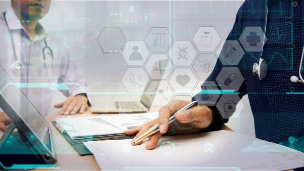 Smart medicine doctor working with computer notebook and digital tablet at desk in the hospital. Medical concept, futuristic virtual interface screen
