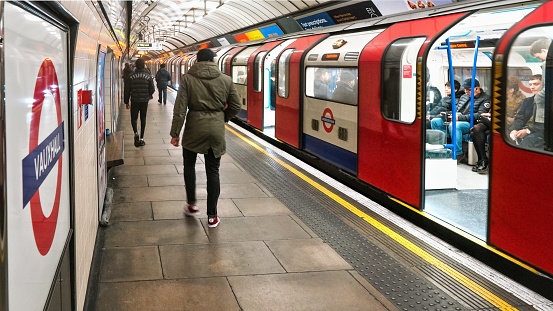 London, United Kingdom - February 02, 2019: Victoria line tube train waiting at Vauxhall station, door open -  passengers walking on the platform