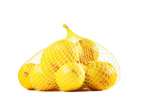 istock group of ripe lemons in a mesh bag against white background 1487512338