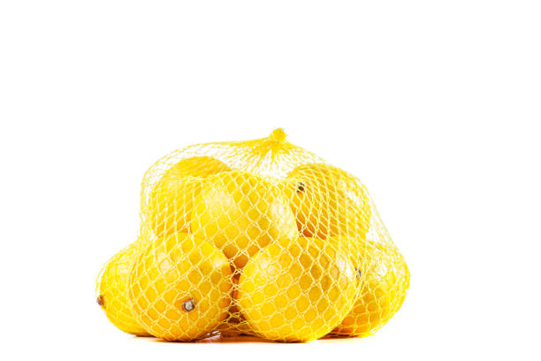 istock group of ripe lemons in a mesh bag against white background 1487512351