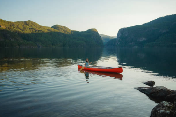 istock Woman canoeing on the lake in Norway 1487513421