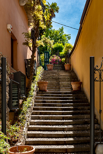 A staircase in Como, Italy..  Viewed from a narrow street in Como.