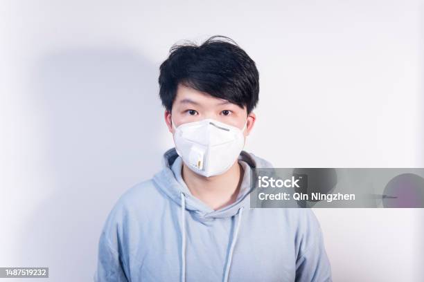 A Man Wearing A N95 Medical Protective Mask Stock Photo - Download Image Now - Surgical Mask, Men, Asian and Indian Ethnicities