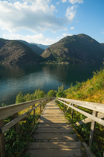 Stairs lead to fjord in Norway  on sunny day in summer