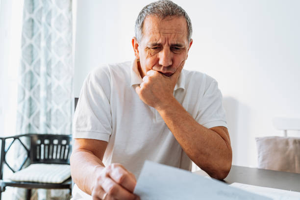 istock Retraining getting an education in middle age, writing an article, checking financial report 1487521528