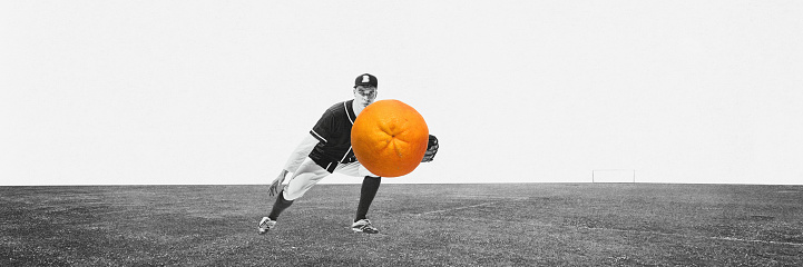 Young man, professional baseball player in uniform catching mandarin instead of ball with gloves over monochrome background. Contemporary art collage. Health, food, nutrition, dietary, sport concept