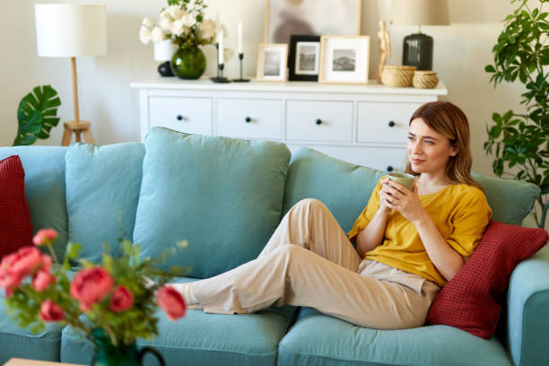 istock An attractive young woman relaxing at home drinking coffee 1487522196