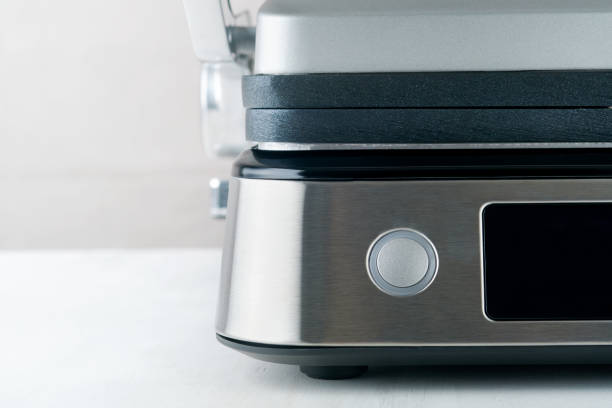 istock Electric grill. Modern kitchen portable grill tool for modern kitchen for grilling meat, vegetables and snacks for dinner or party on light gray background. Place for text or advertisement. Mock up. 1487523814