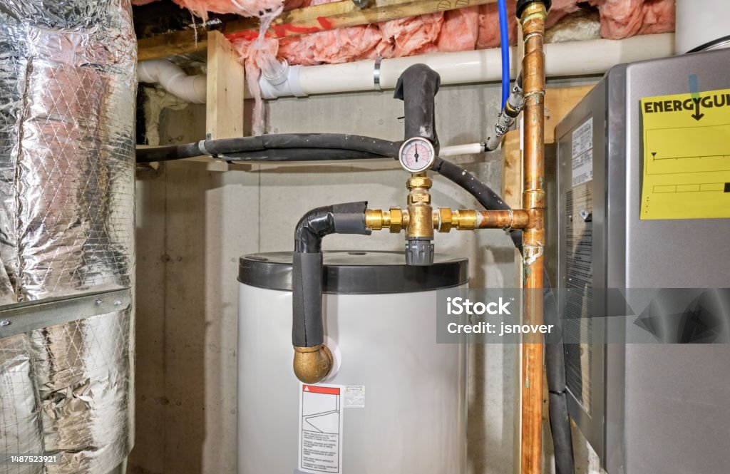 Thermostatic mixing valve Thermostatic mixing valve regulating temperature for home's hot water to a safe level Boiler Stock Photo